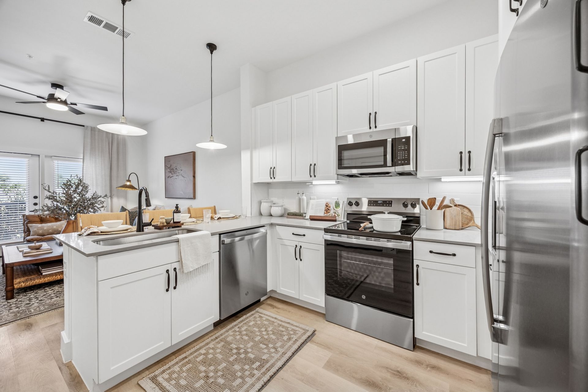 A kitchen with white cabinets and stainless steel appliances.
