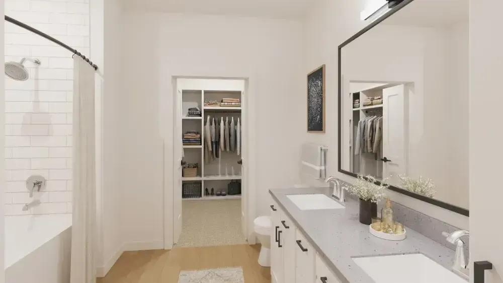 A bathroom with two sinks , a toilet , and a walk in closet.
