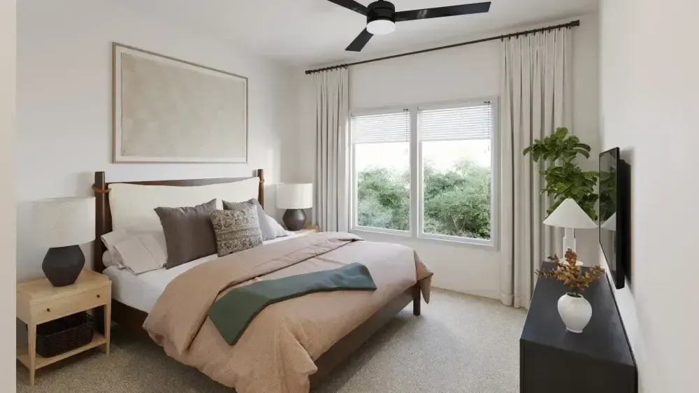 A bedroom with a large bed and a ceiling fan