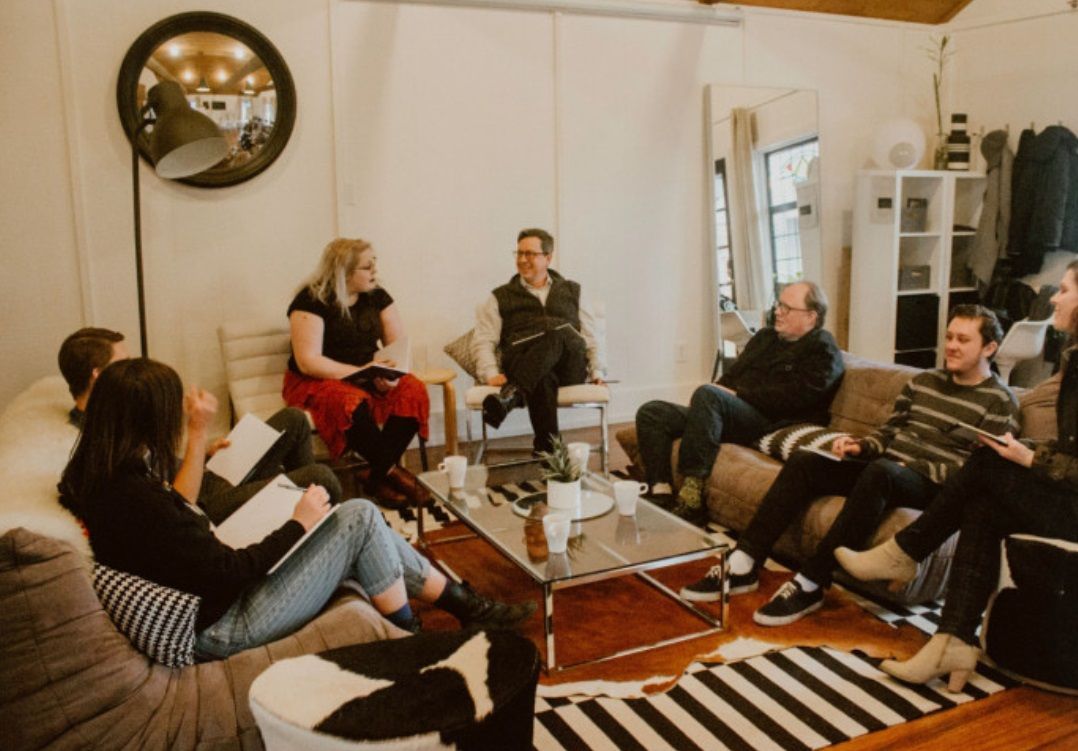 Interior of The Cottage Meeting Space with projector screen, seating for meetings or private events on Vashon Island.