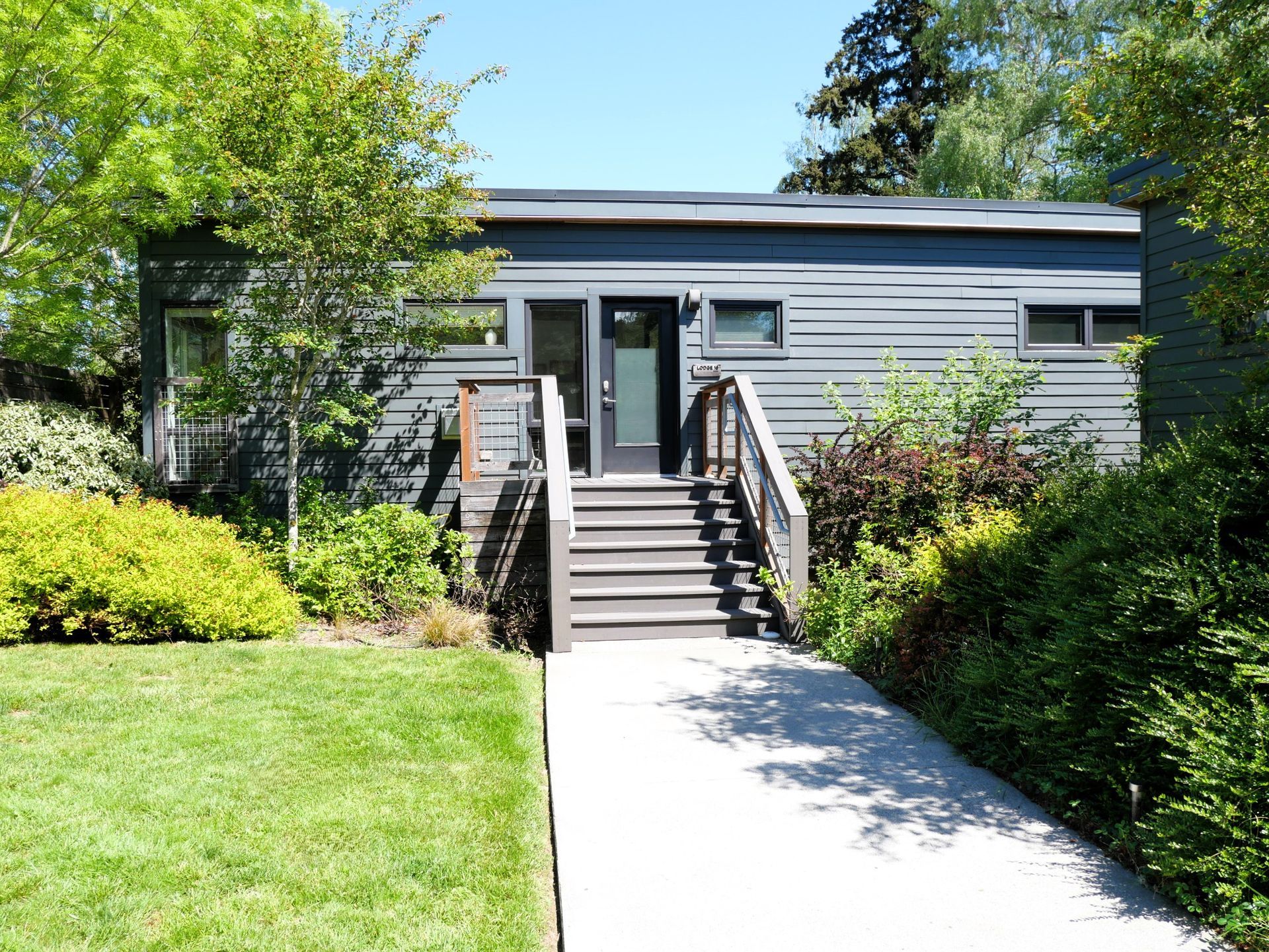 Courtyard King Lodge exterior at The Lodges on Vashon — modern, pet-friendly lodging near Seattle.