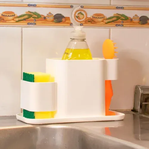 Organizador de fregadero de cocina de plástico blanco con botella de jabón y esponja.