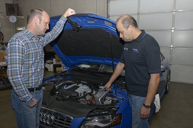 Two Man Inspecting Car — Portland, OR — Hillside Imports