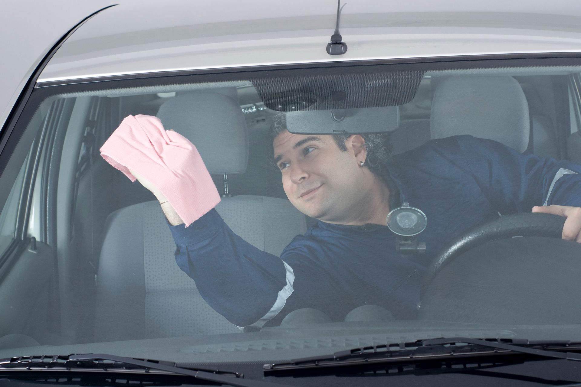 A men washing the car windows and Interior | Hillside Imports