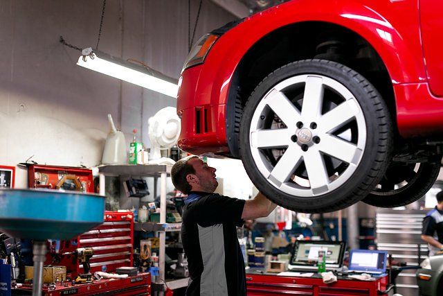Man Repairing Red Car — Portland, OR — Hillside Imports