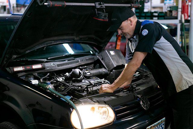 Man Inspecting Car damage — Portland, OR — Hillside Imports