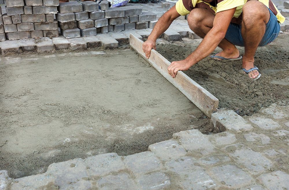 a man working on a construction site with bricks