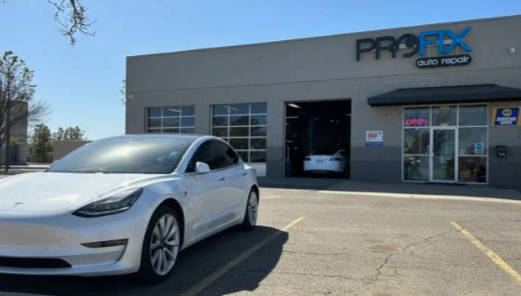 Exterior Of PROFIX Auto Repair Shop With White Tesla Parked Outside | PROFIX Auto Repair