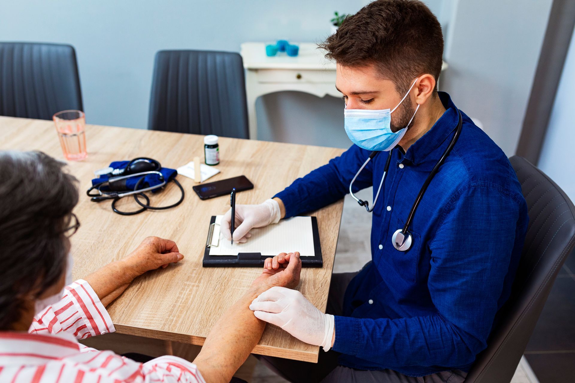 Doctor Monitoring A Patient's Pulse Rate — Chicago, IL — Chicagoland Home Physicians