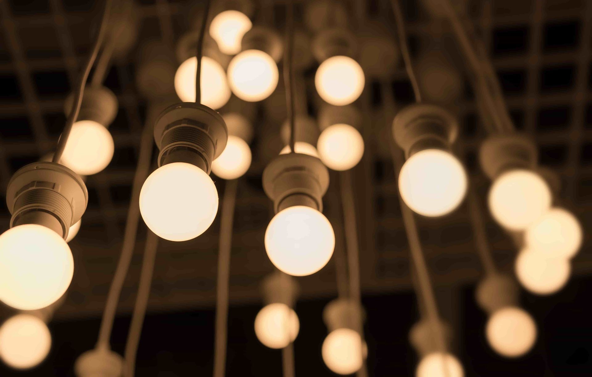 A Blue Light Bulb is Hanging From the Ceiling in a Room — Rob Fritsch Electrical in Wagga Wagga, NSW