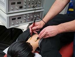 Electrotherapy treatment applied to neck for pain management and muscle relief