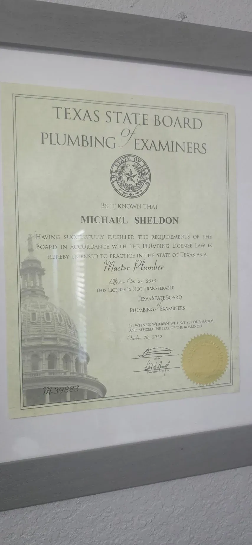 Framed Texas State Board of Plumbing Examiners certificate. Shows name 