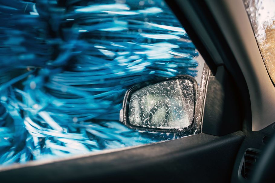 A car is being washed in a car wash.