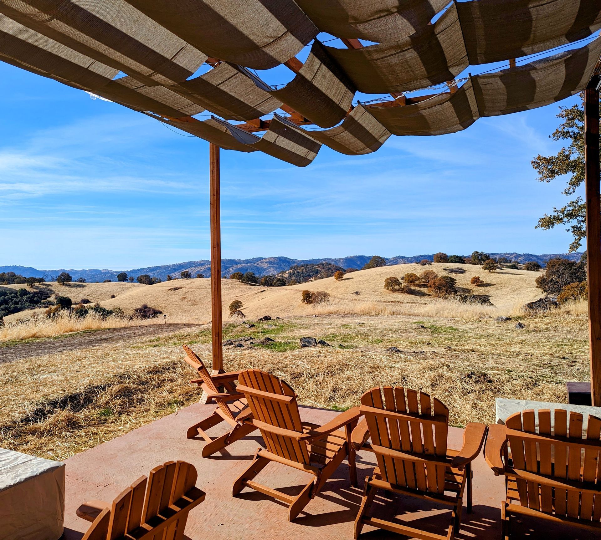 A patio with chairs and a table under an umbrella