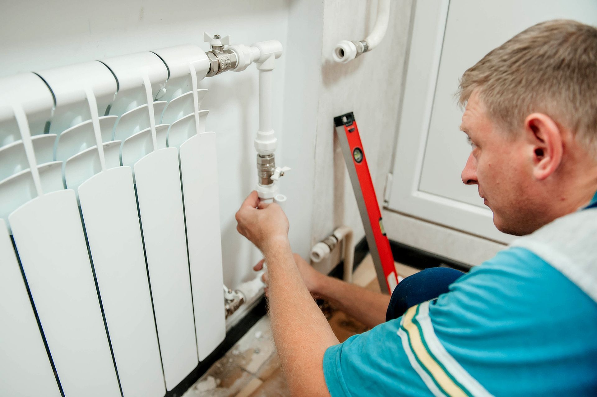 A man is installing a radiator.