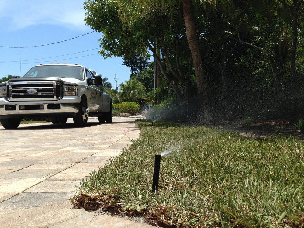 Corner Of Lawn With Sprinkler — Port Charlotte, FL  — American Irrigation