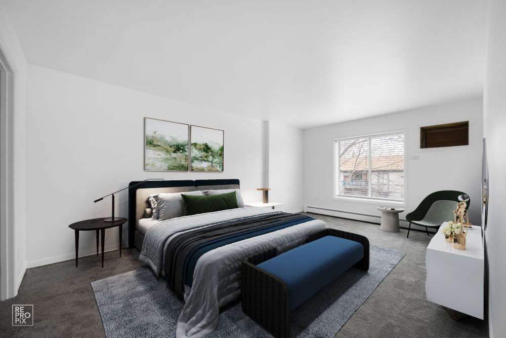 A bedroom with a large bed and a blue bench