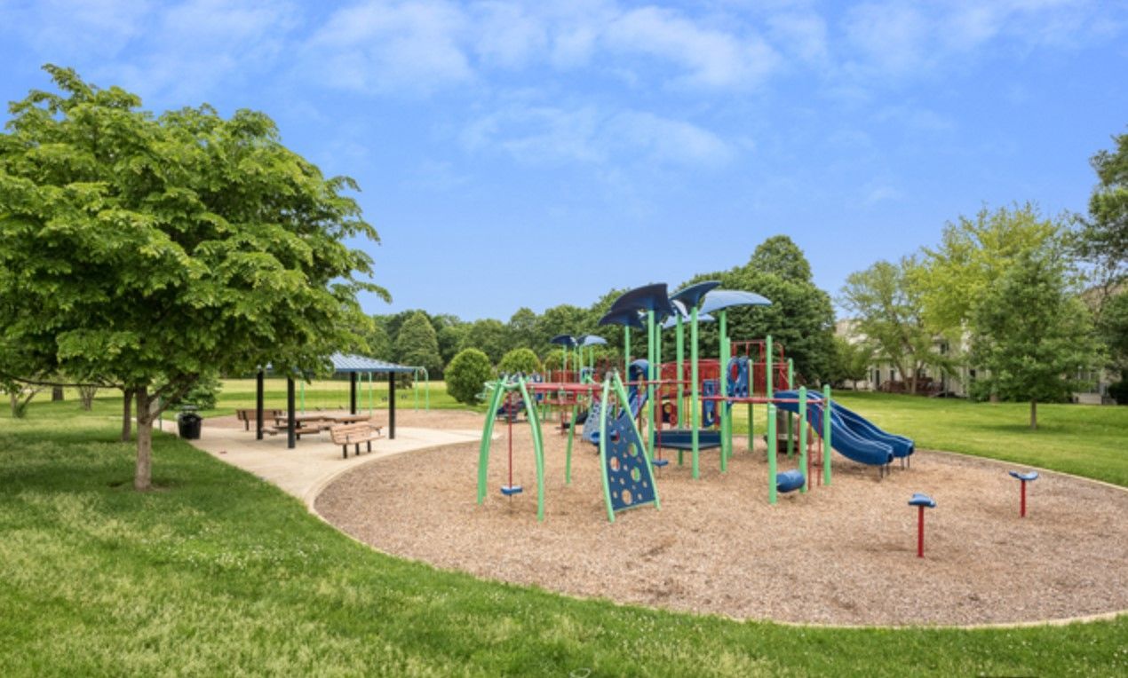 There is a playground in the middle of the park.