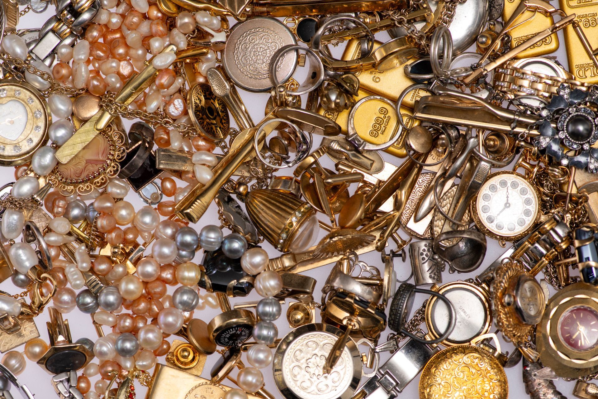 Different types of antique jewellery lie in a clutter on a white background. Different types of antique jewellery lie in a clutter on a white background.