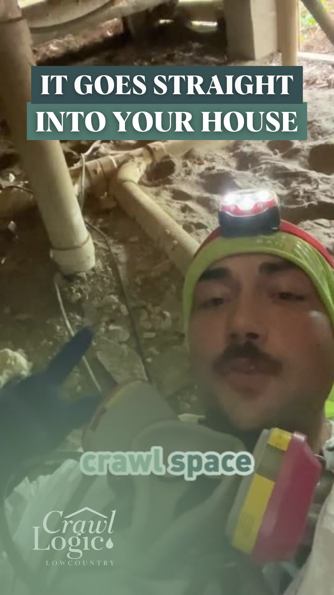 A man is laying in the dirt with a flashlight on his head.