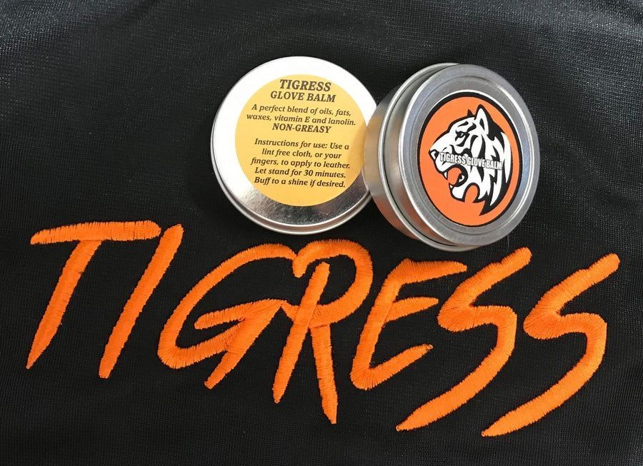 a black background with the word tigress on it and softball glove balm products on top.