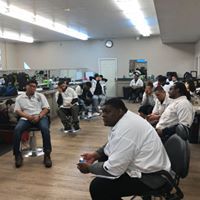 A group of people are sitting in a circle in a room.