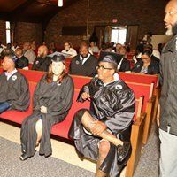 A group of graduates are sitting in a church.