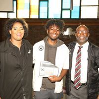 A group of people are posing for a picture in a room.
