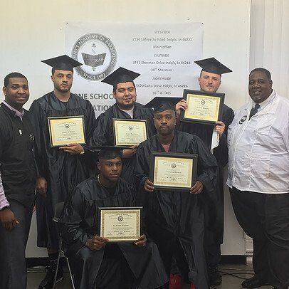 A group of men in graduation caps and gowns are posing for a picture.