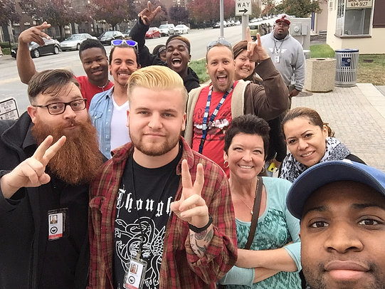 A group of people are posing for a picture and one of them is wearing a shirt that says thought