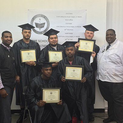 A group of graduates are posing for a picture while holding their diplomas.