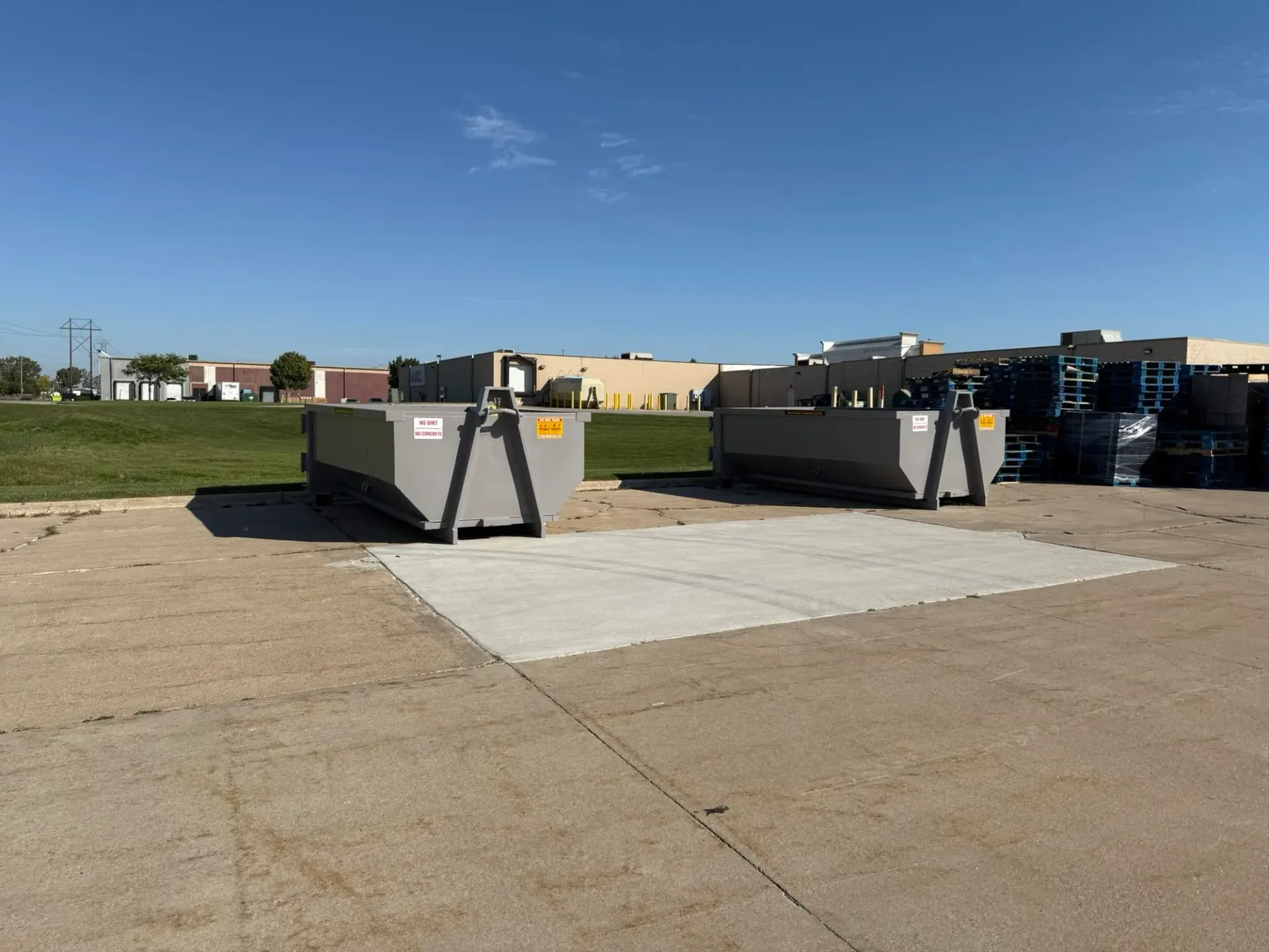 A dumpster with the word brialey on the side is parked in a driveway.