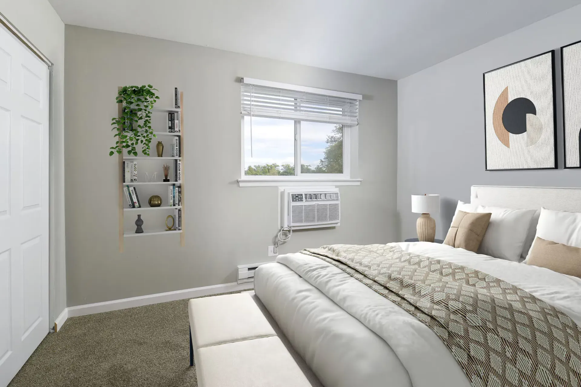 Bedroom in an apartment featuring a bed, bench, bookshelf, and a window air conditioner at The Addison, offers townhomes for rent in North Wales near Delaware Valley University.