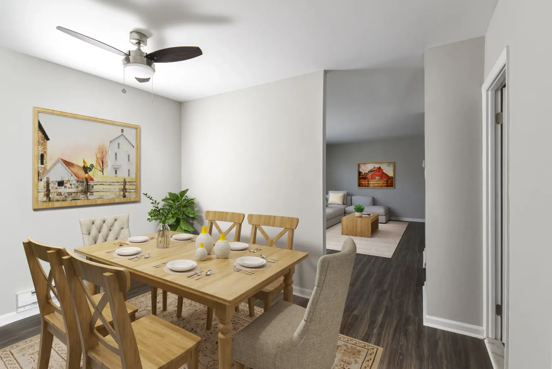 Dining area in a neutral-toned apartment with a wooden table and six chairs at The Addison, offers townhomes for rent in North Wales near Delaware Valley University.