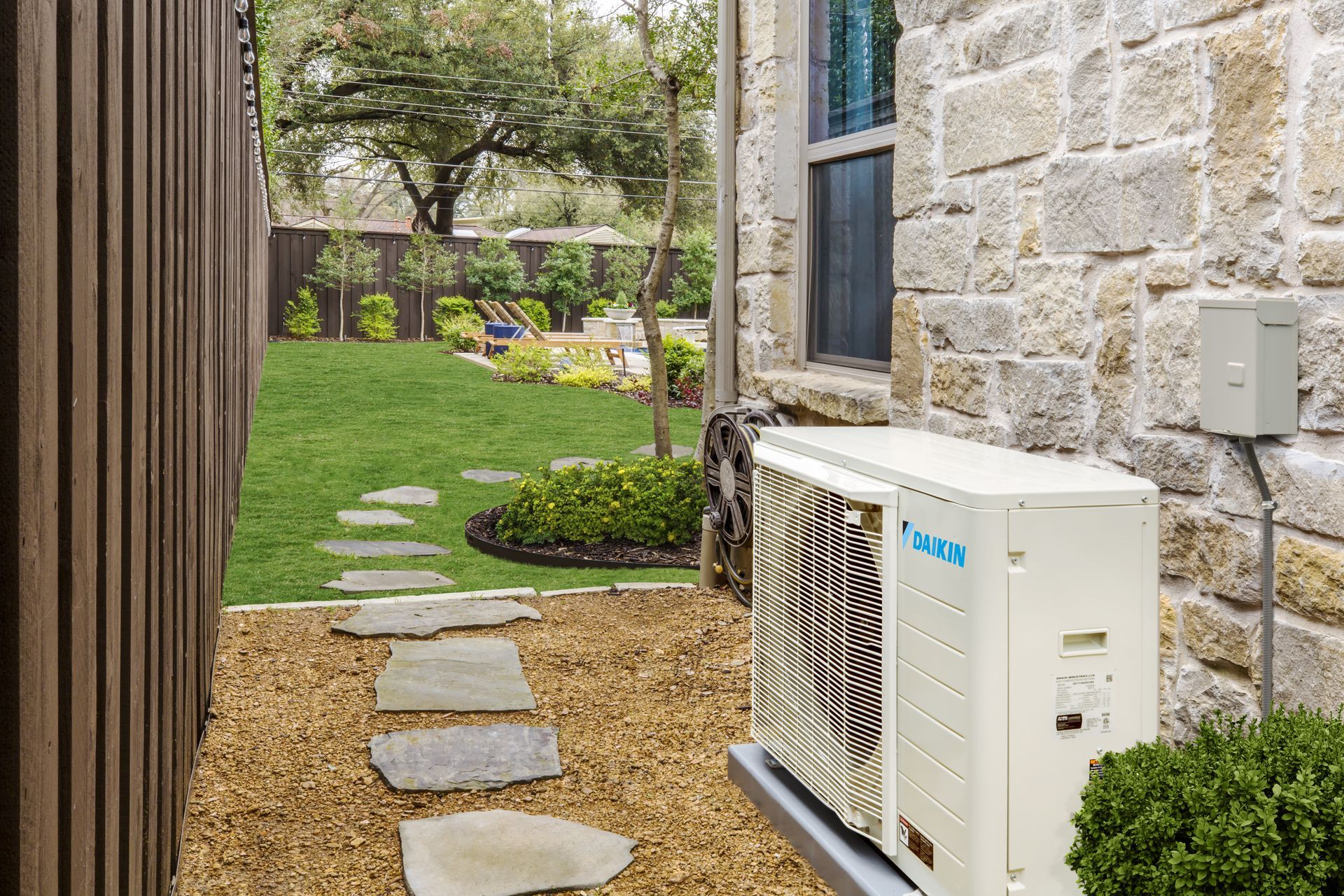 Technician servicing a Daikin HVAC unit using R32 refrigerant for energy-efficient cooling in 2025.