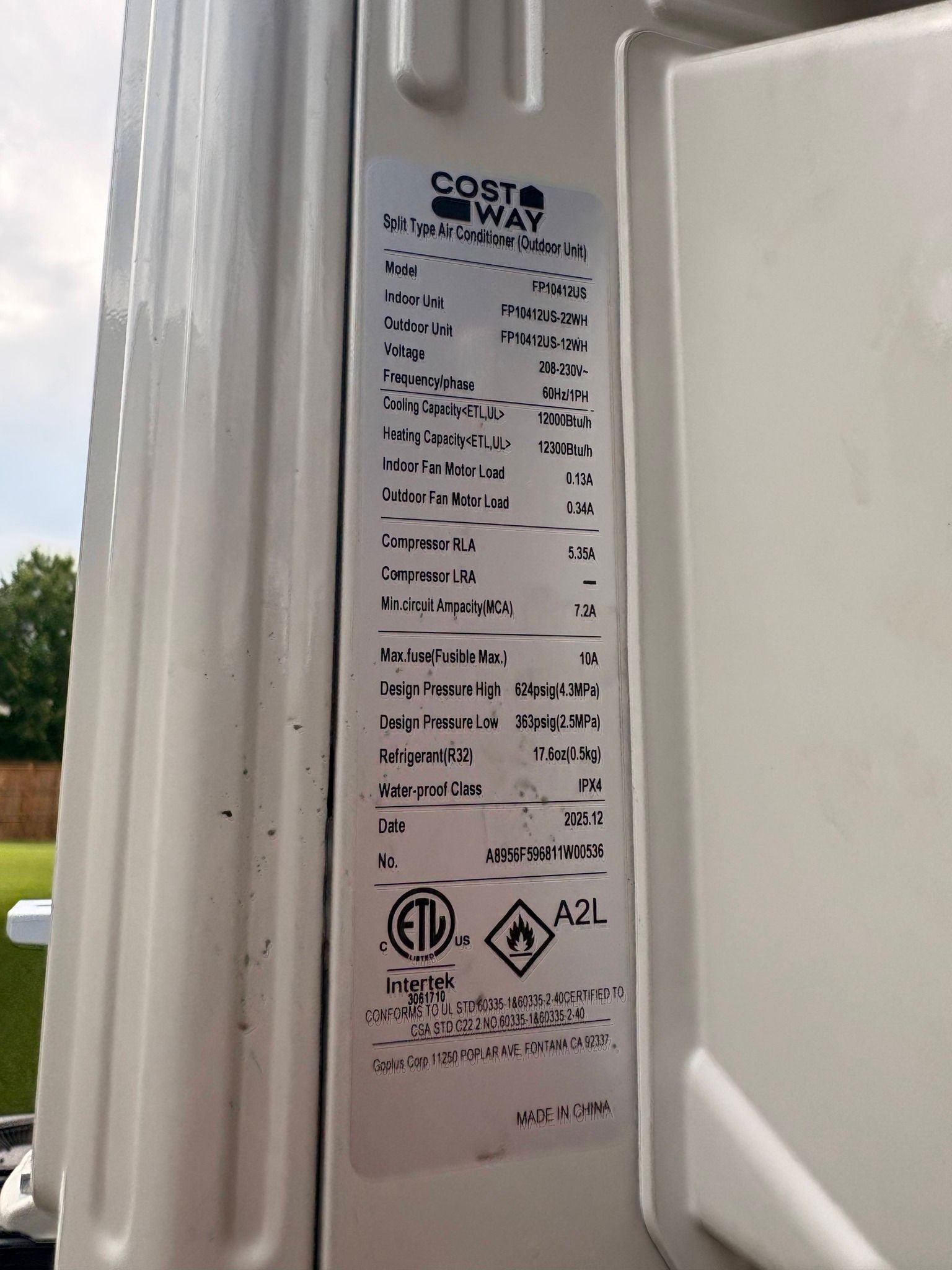 Close-up of a white appliance door jamb with a manufacturer label and electrical specifications.