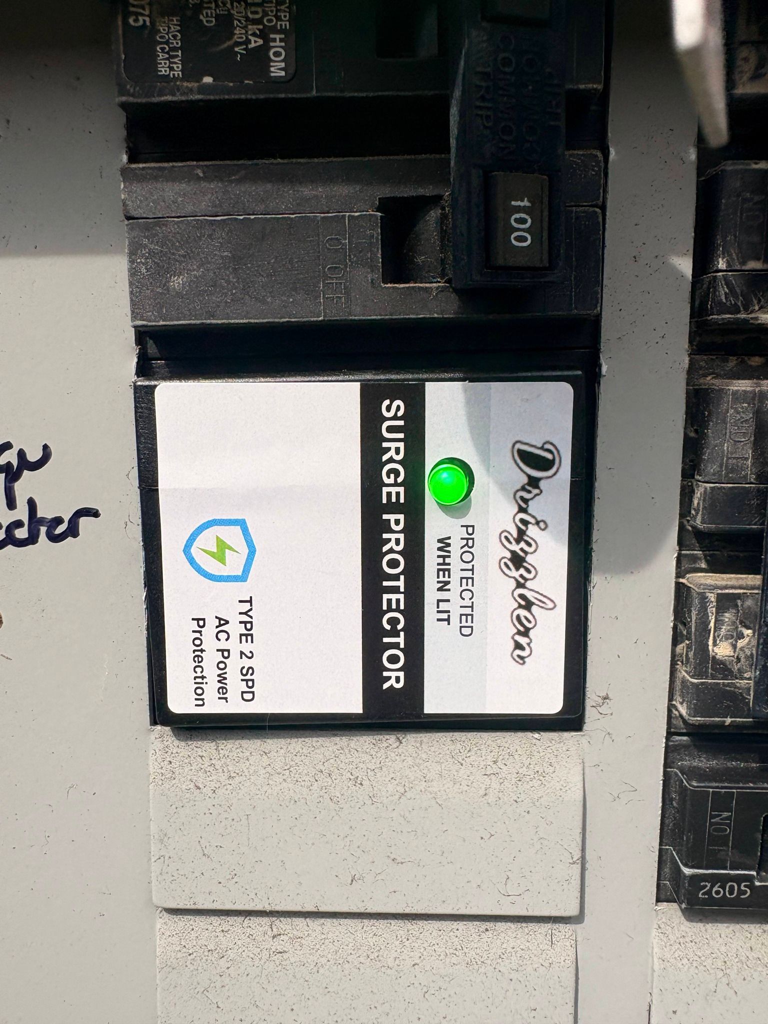 Close-up of a white and black power module with a green LED labeled “SUPER PROTECTOR.”