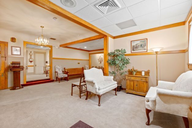 A living room with a couch and chairs in it