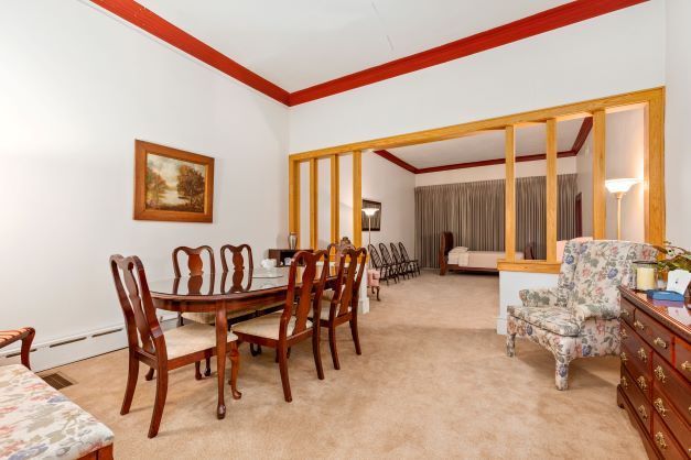 A living room with a dining table and chairs