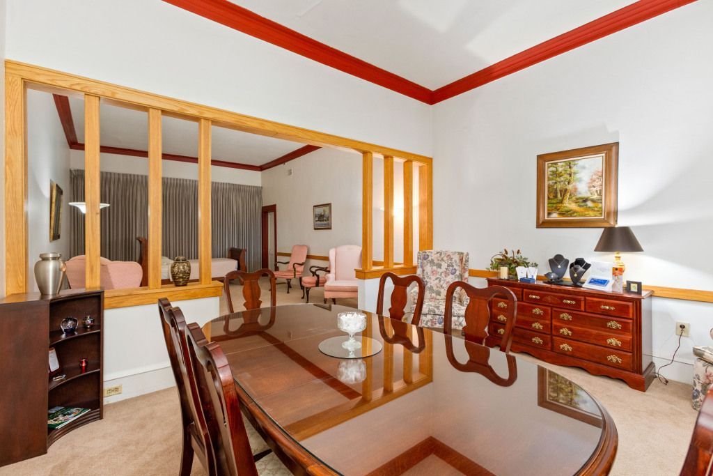 A dining room with a large table and chairs