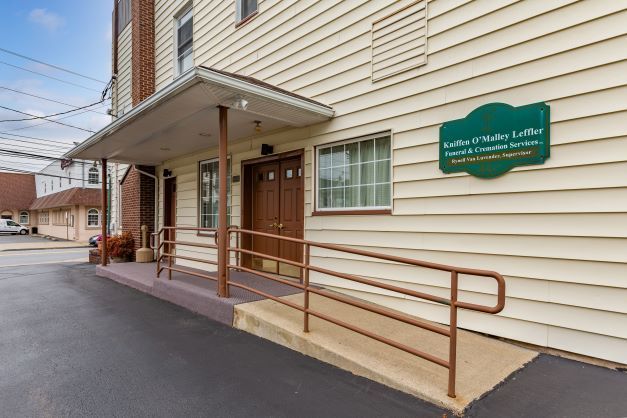 A building with a ramp and a sign on the side of it.