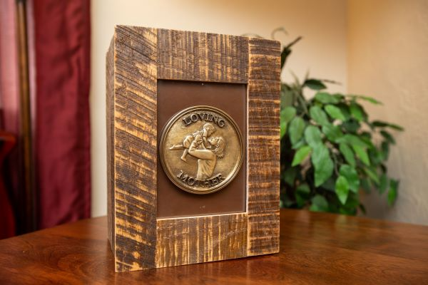 A picture frame with a coin on it is sitting on a wooden table.