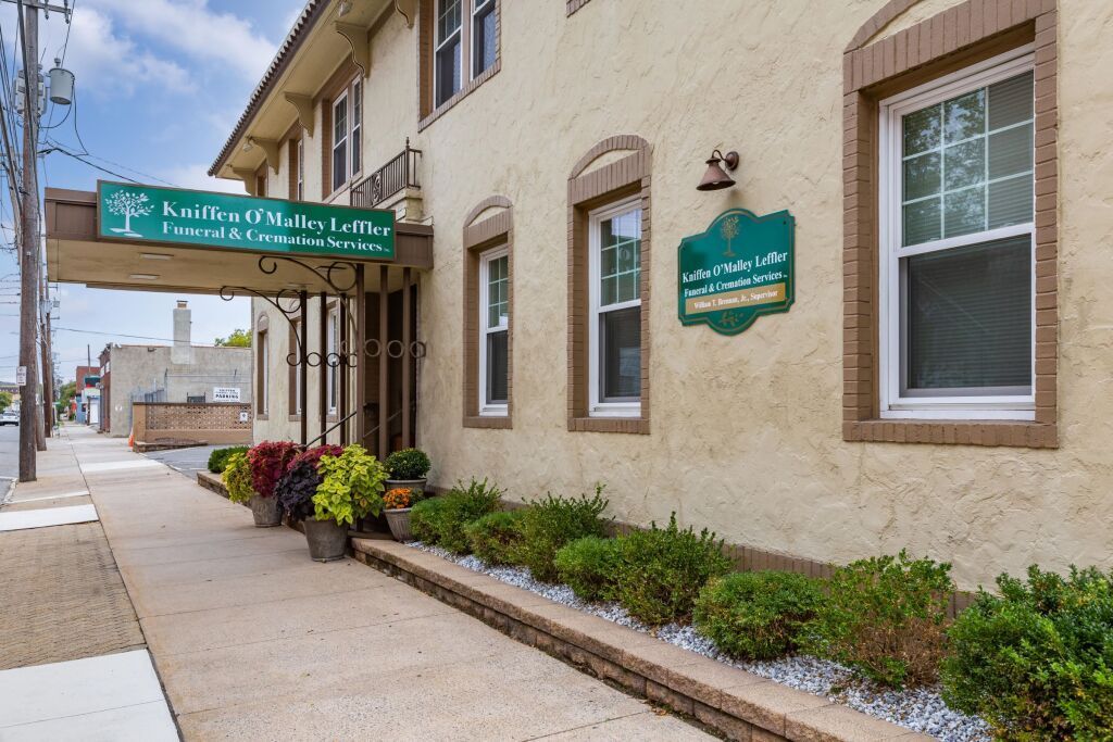 A large building with a green sign on the side of it.