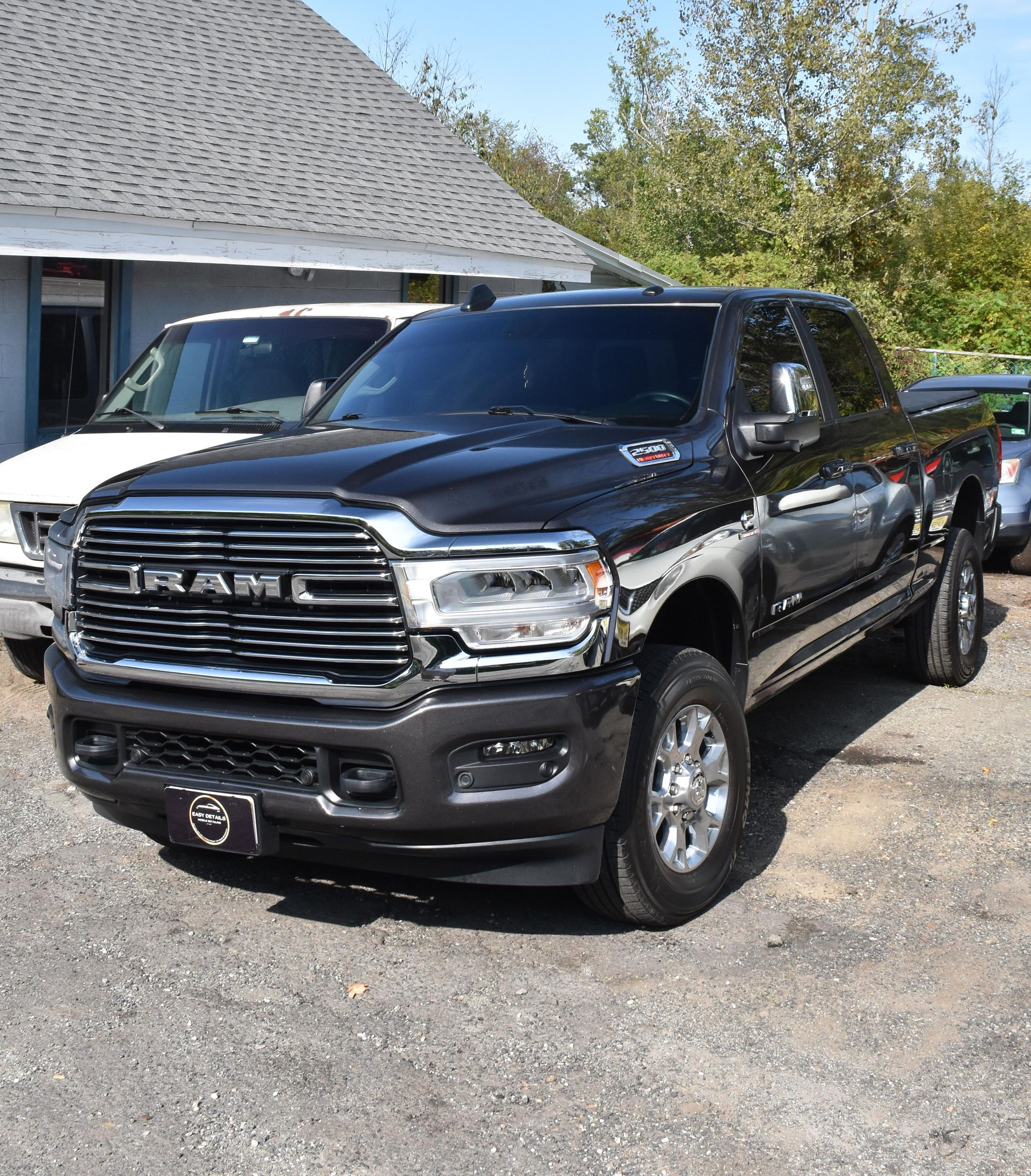Dark gray RAM pickup truck parked in front of a building.