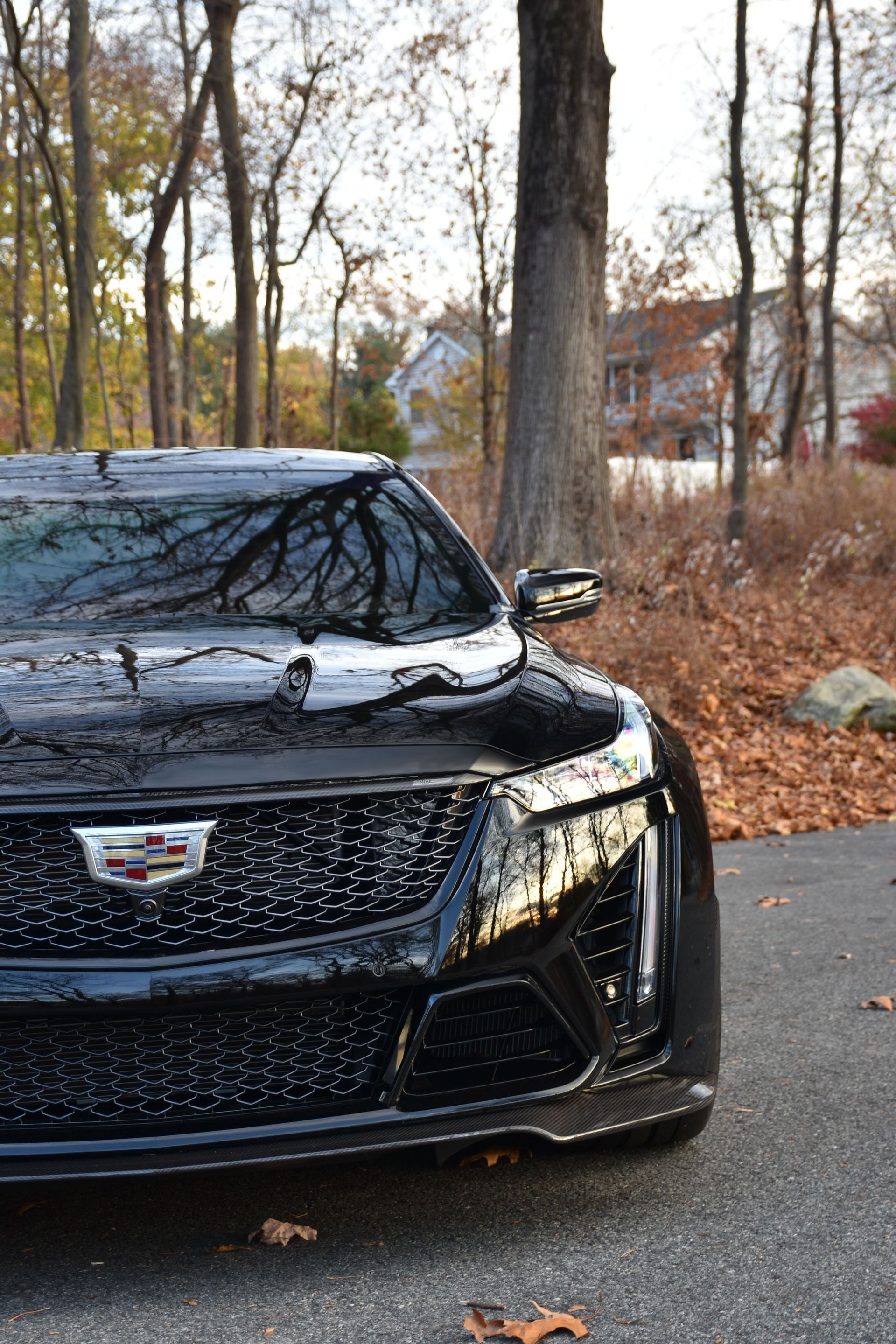 a man is polishing the hood of a car with a machine .