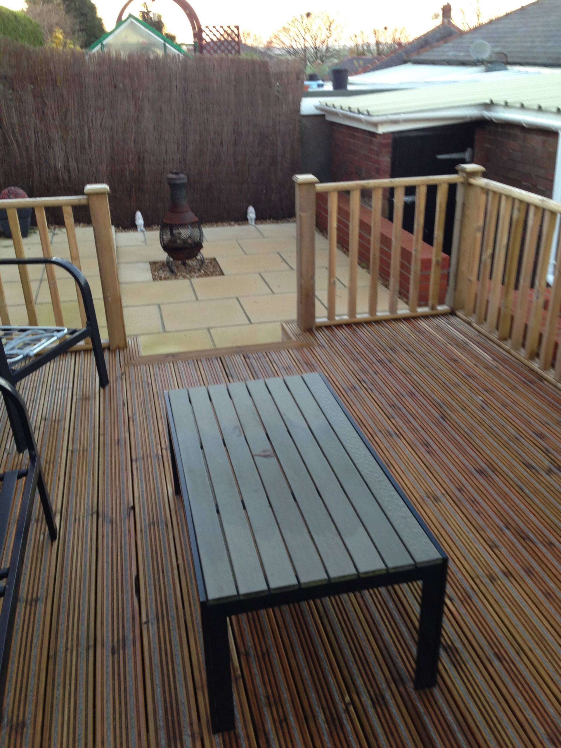 wooden bench and chairs on the newly installed deck