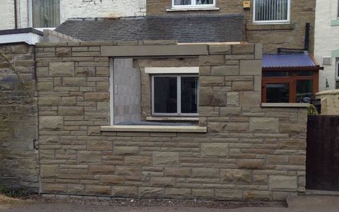 house extension under construction with open front windows