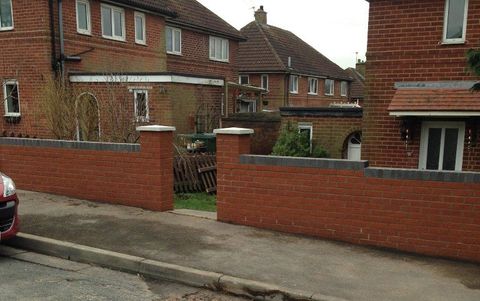 two brick houses with brick fencing