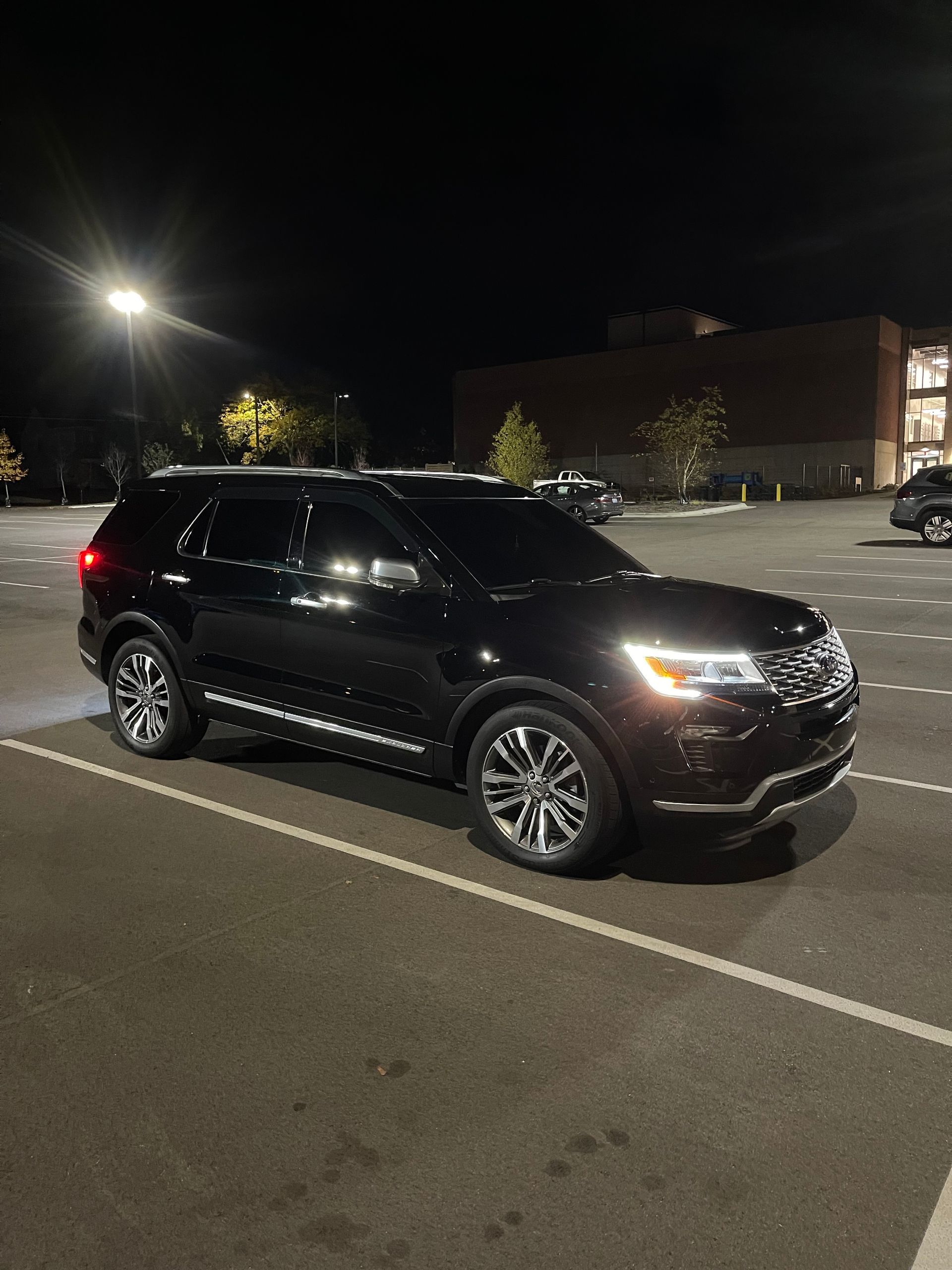 Sliding glass doors with silver frames on white building; dark tinted glass.