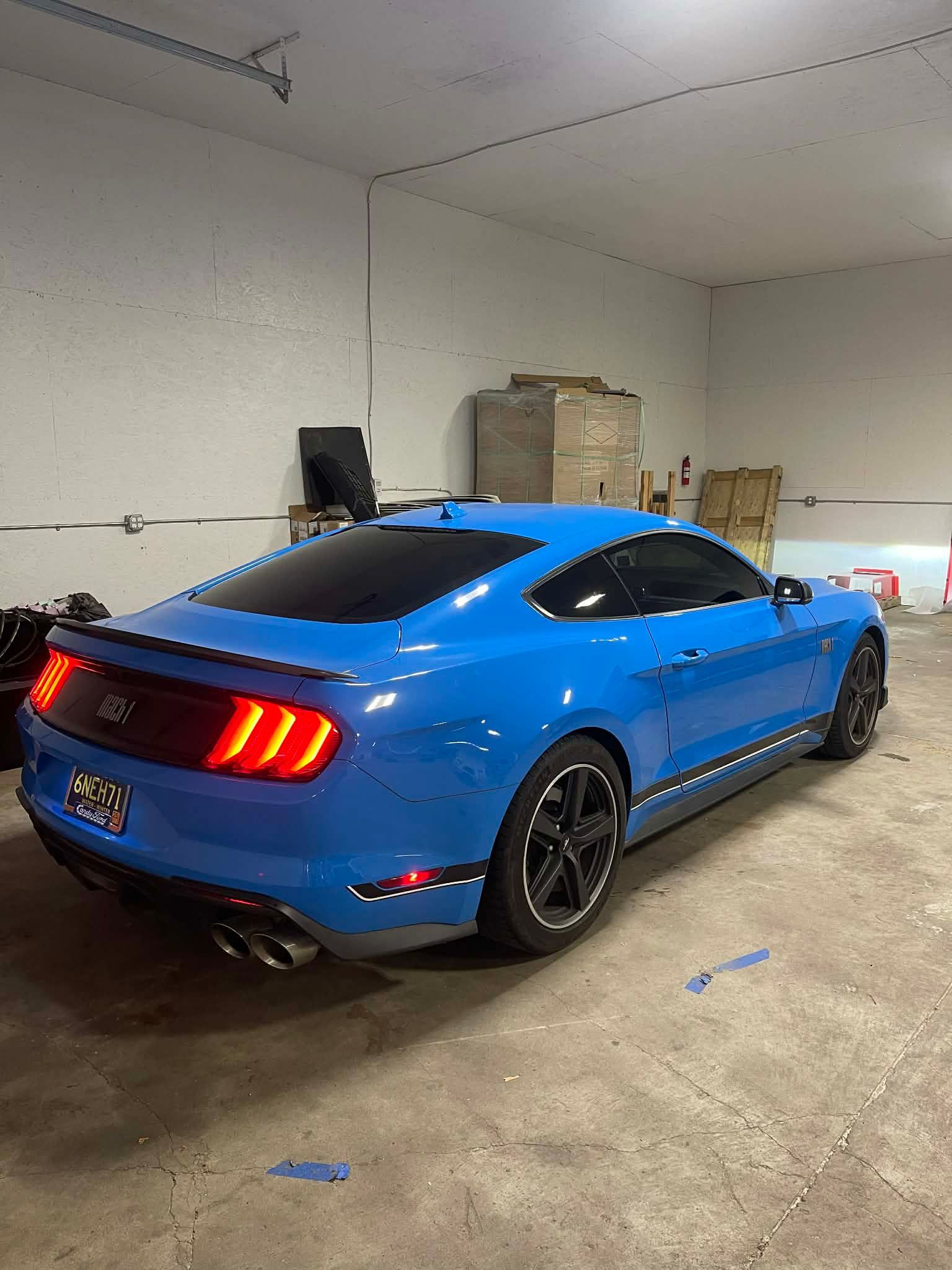 Blue Ford Mustang in a garage.